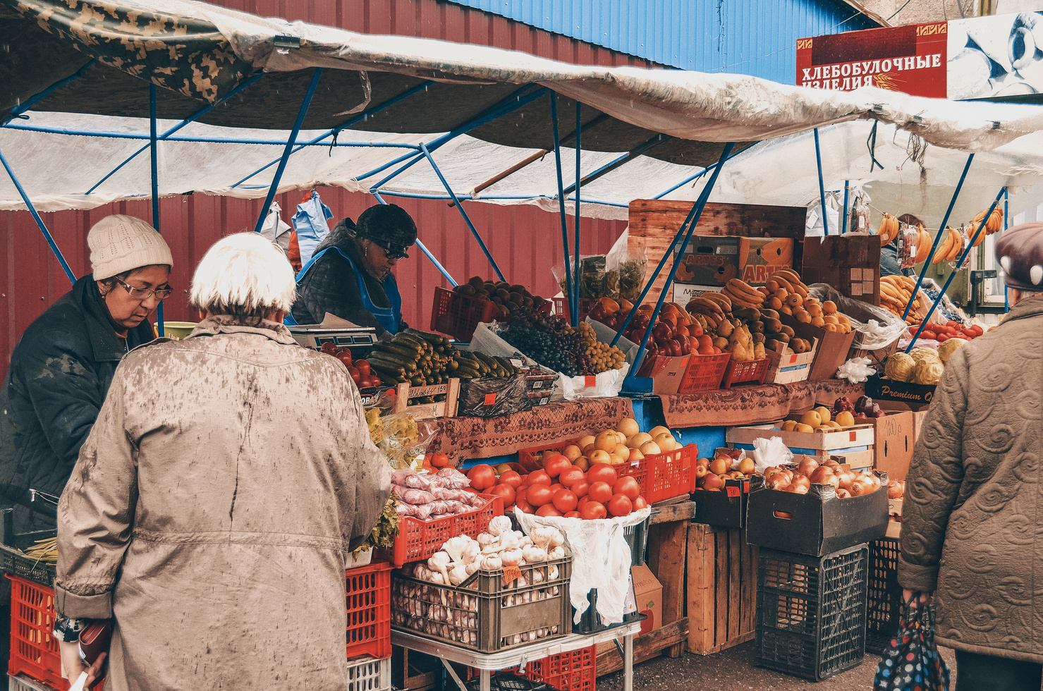 Unrecognizable customers and vendors in street food market